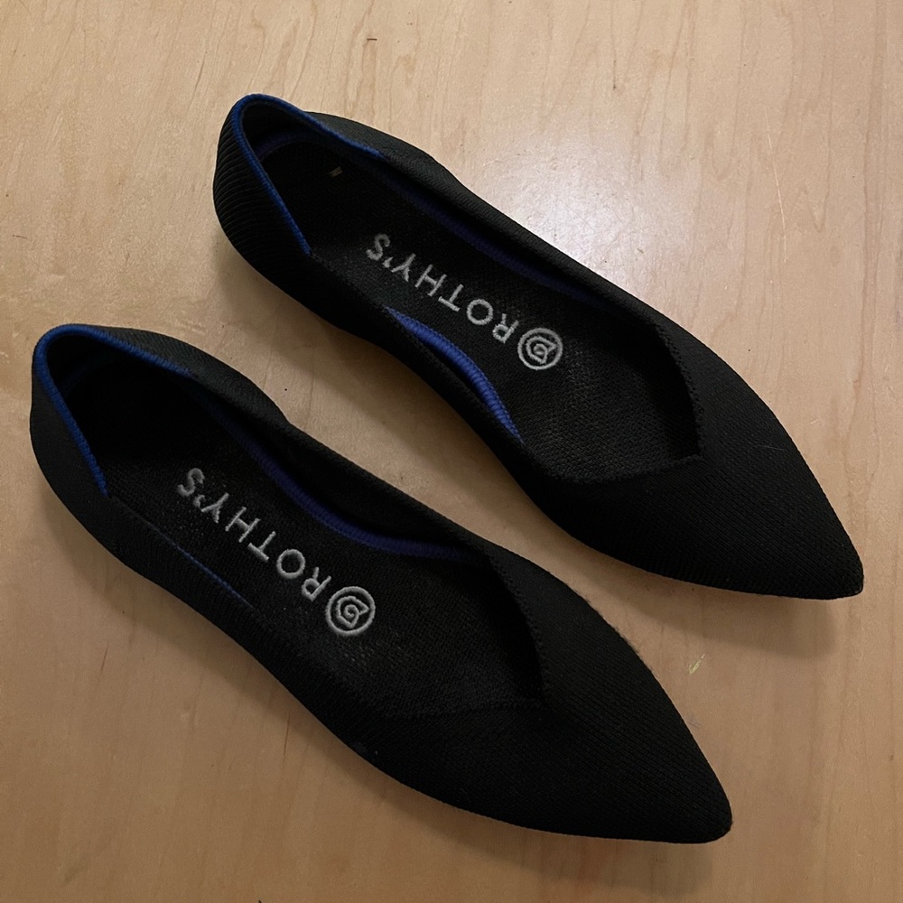 Classic comfy black Rothy’s shoes with blue trim